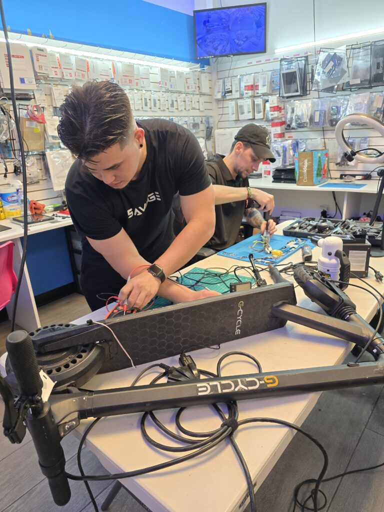 Technician repairing an electric scooter at Techy Doral near Doral, FL