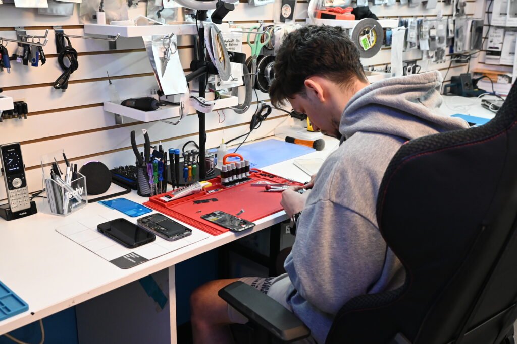 Phone repair technician at work at Techy Doral in Sweetwater, FL